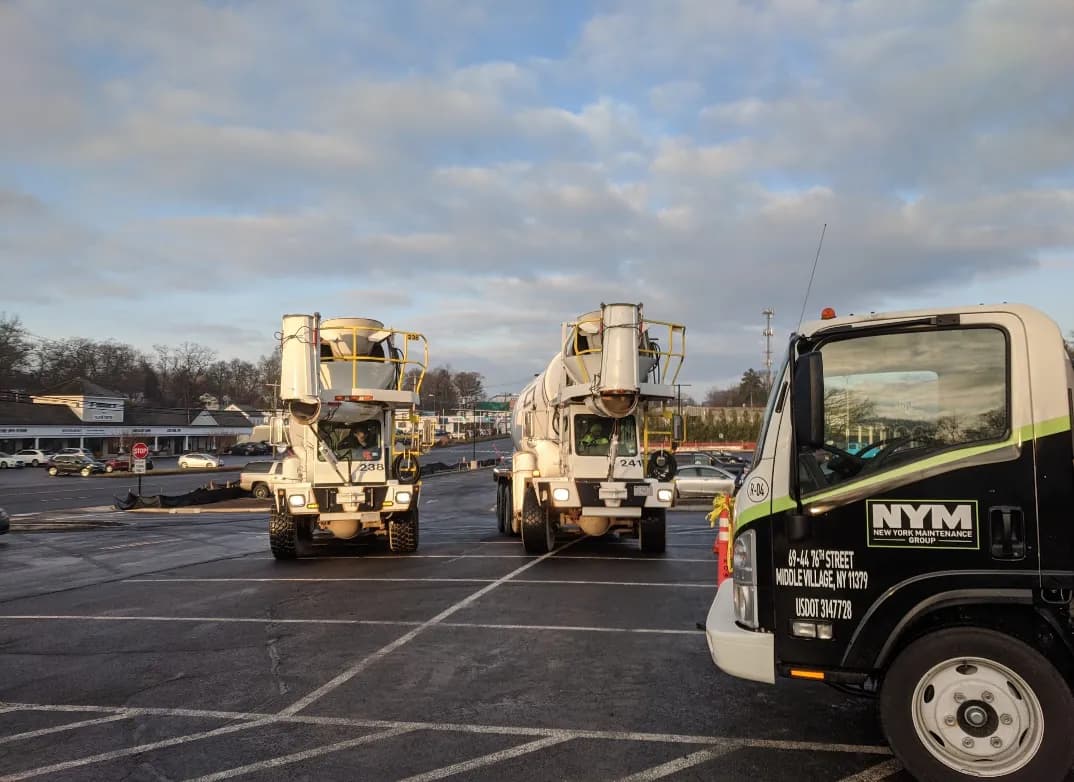 NYM Group concrete mixer trucks staged on a commercial job site